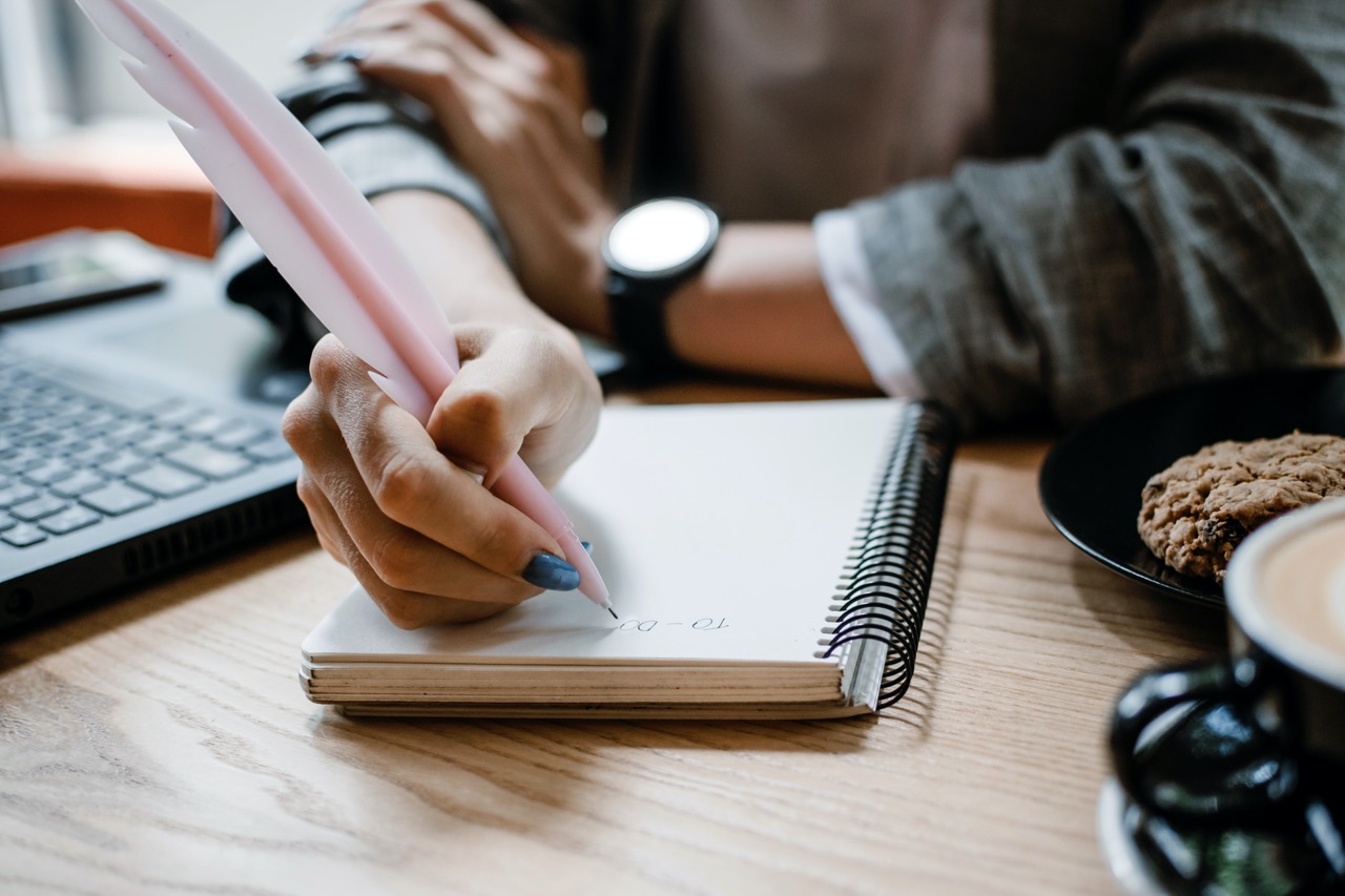 To do list, organize plans, projects, checklist, Productivity Works. Woman writing to do list. Close